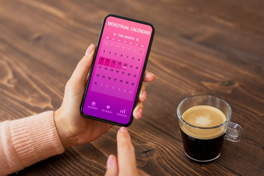 Person Using a Period Tracker App in Smartphone