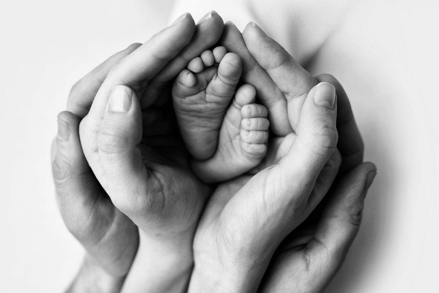 Parents Holding Feet of Newborn Baby